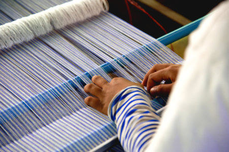 Entwtined worker making silk cloth